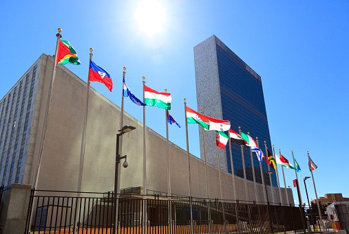 Various national flags in front of the UN headquarters 