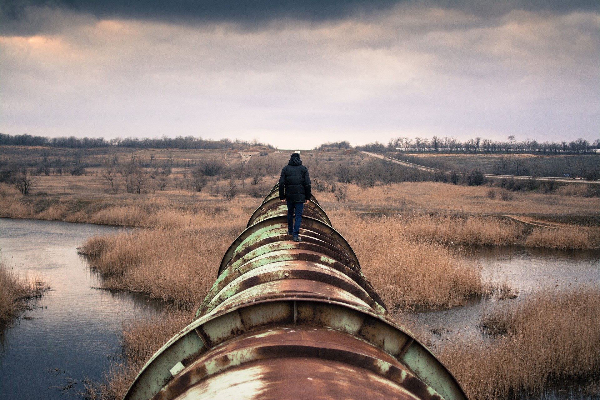 person walking on pipeline